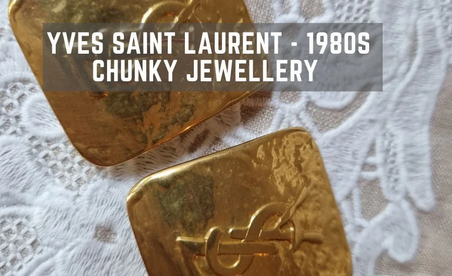 Gold square Yves Saint Laurent earrings on lace, captioned "Yves Saint Laurent - 1980s Chunky Jewellery"