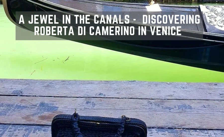 Black woven handbag on a wooden landing stage beside a gondola on a green Venice canal
