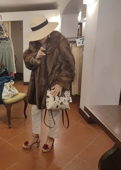 Vintage 1980s Fendi fur: a brown fur coat with a cream hat, cow-print handbag and flower-trimmed heels