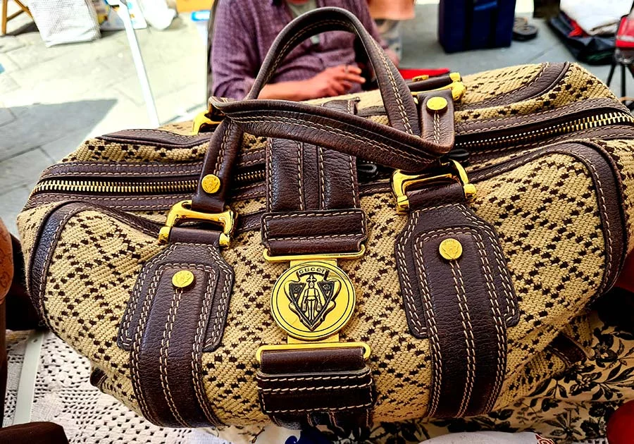 Vintage Gucci bag in beige diamond-pattern canvas with brown leather trim, gold-tone buckles and a crest plaque