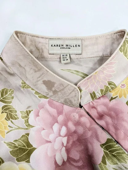 Karen Millen England label inside the collar of a pink floral silk top