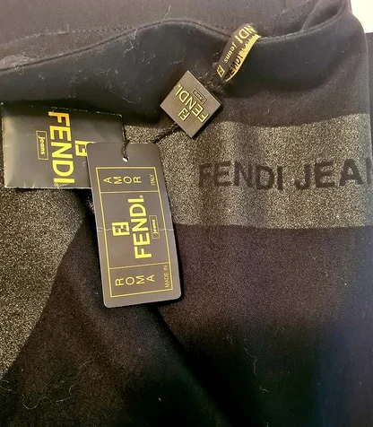 Black garment with Fendi Jeans swing tags and a grey Fendi Jeans band printed across it