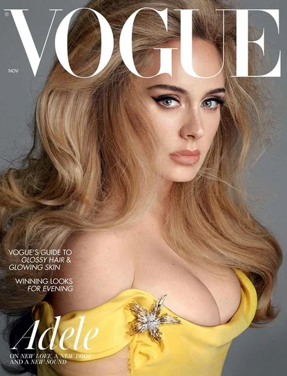 Vogue cover with Adele in voluminous waved hair and winged eyeliner, wearing a yellow gown