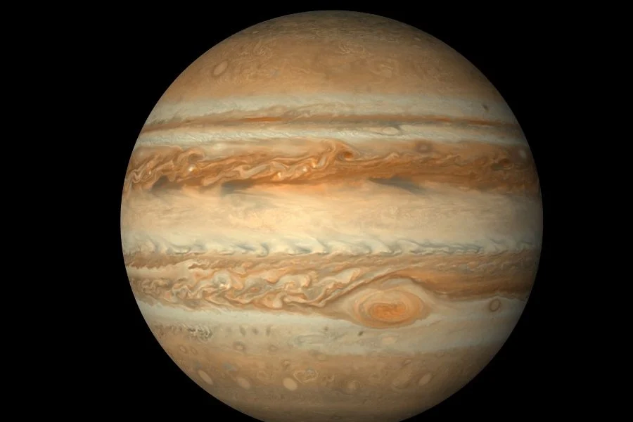 The planet Jupiter against a black background, showing its cloud bands and the Great Red Spot