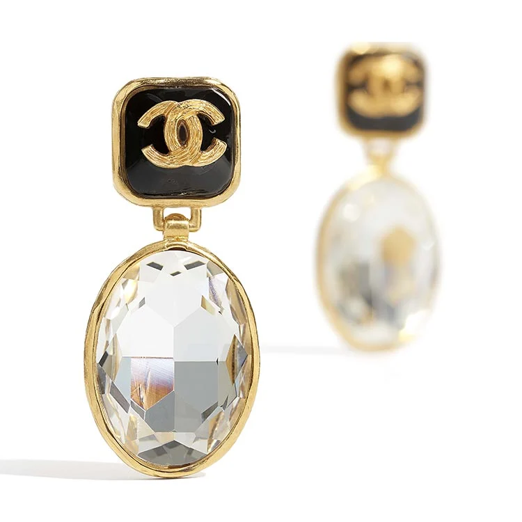 Chanel clip earring with a black enamel interlocking CC logo above a large oval crystal drop in a gold-tone frame