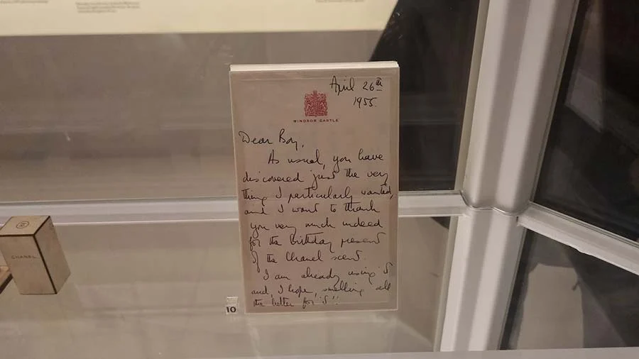 Handwritten letter dated April 1955 on Windsor Castle notepaper, displayed in a museum case