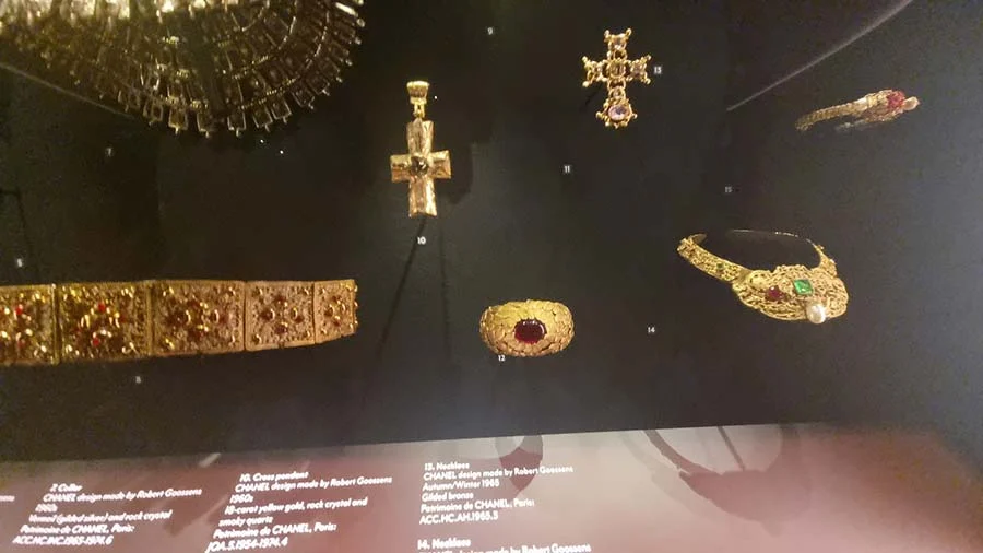 Gold-toned crosses, a collar and a red-stone ring, Robert Goossens designs for Chanel, in a museum case