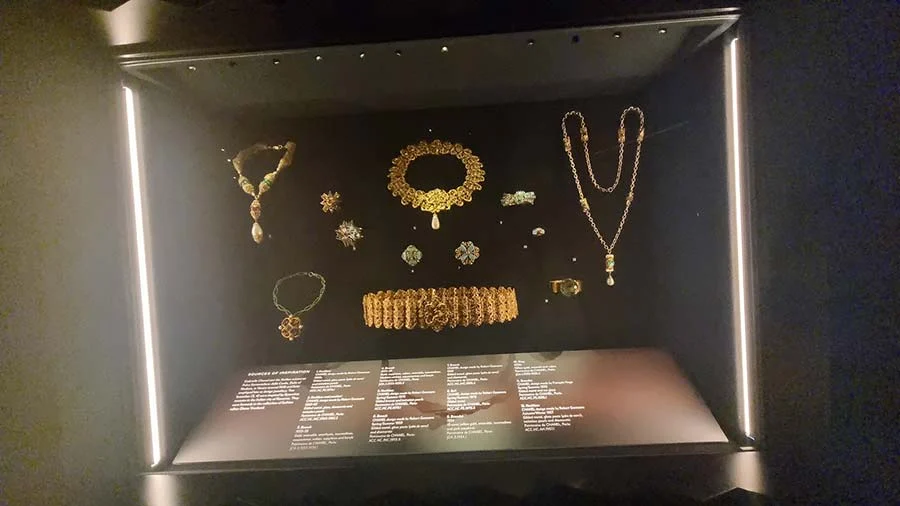 The same jewellery case from another angle, with a wide cuff and a long chain necklace