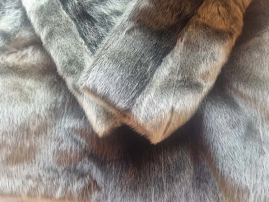 Close-up of the grey-brown collar and cuff of a vintage seal fur coat