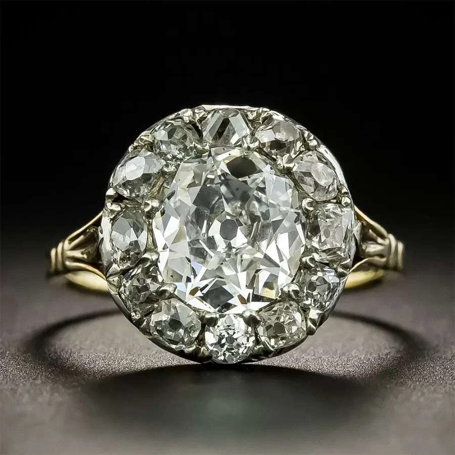 Antique cluster ring: a large old-cut diamond surrounded by a halo of smaller diamonds on a gold band